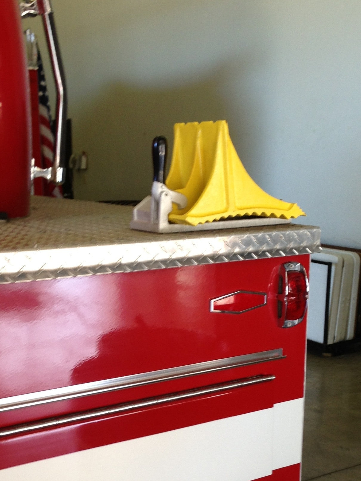 Heavy Duty aluminum cast Wheel Chock by Zephyr Industries mounted on fire truck